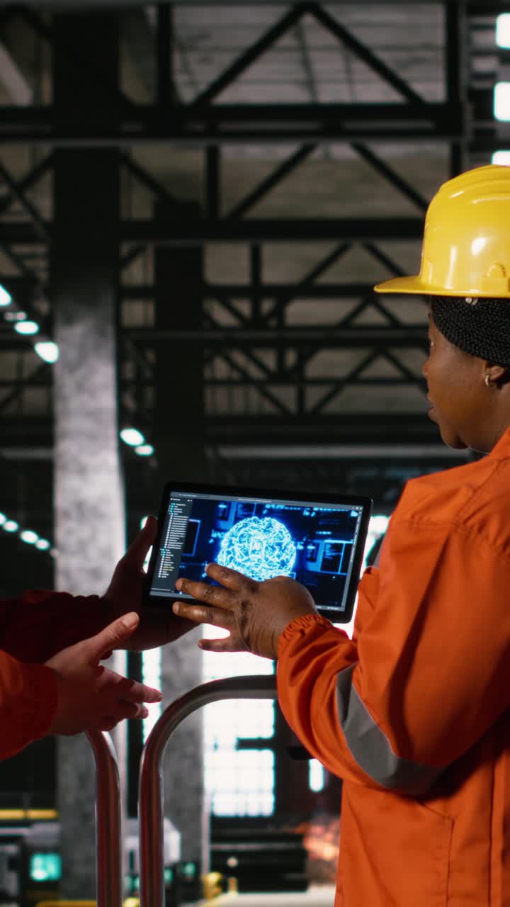Vertical Video Two staff members examine artificial intelligence ...