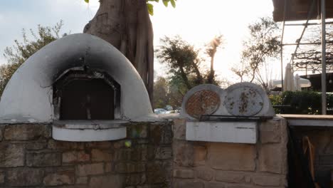 side view of white concrete stove on street by the summer terrace of restaurant