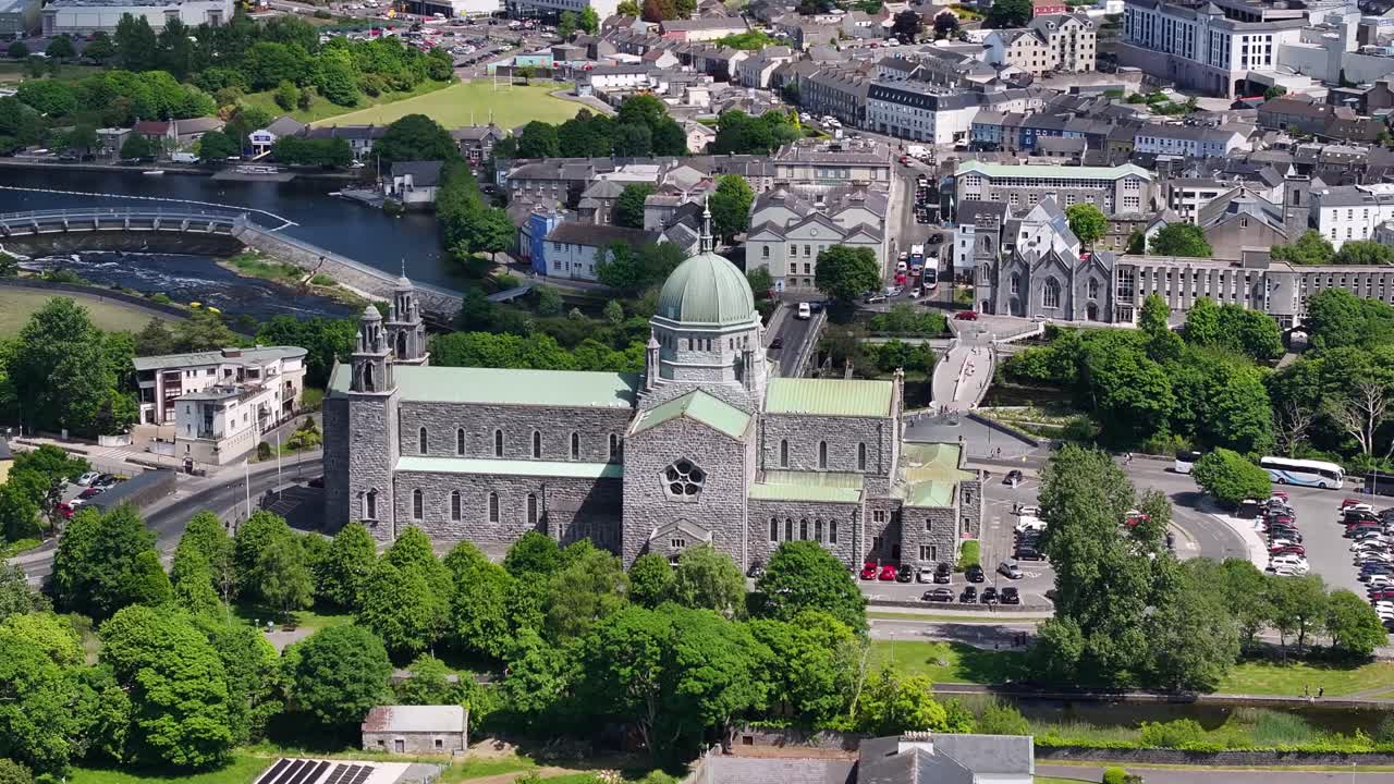 Galway Cathedral, church and historic buildings on riverside. Landmark in Ireland, cultural heritage.