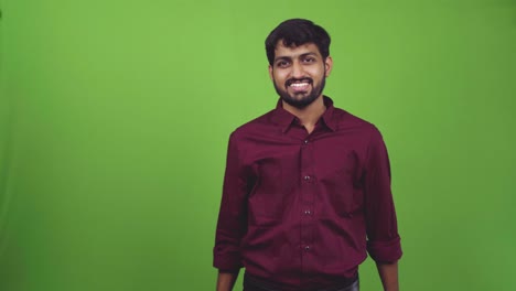 attractive person pointing towards camera and shows come to me, isolated on green screen