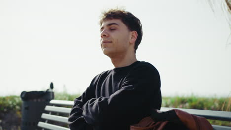 tired and stressed man on a bench outdoor trying to recover
