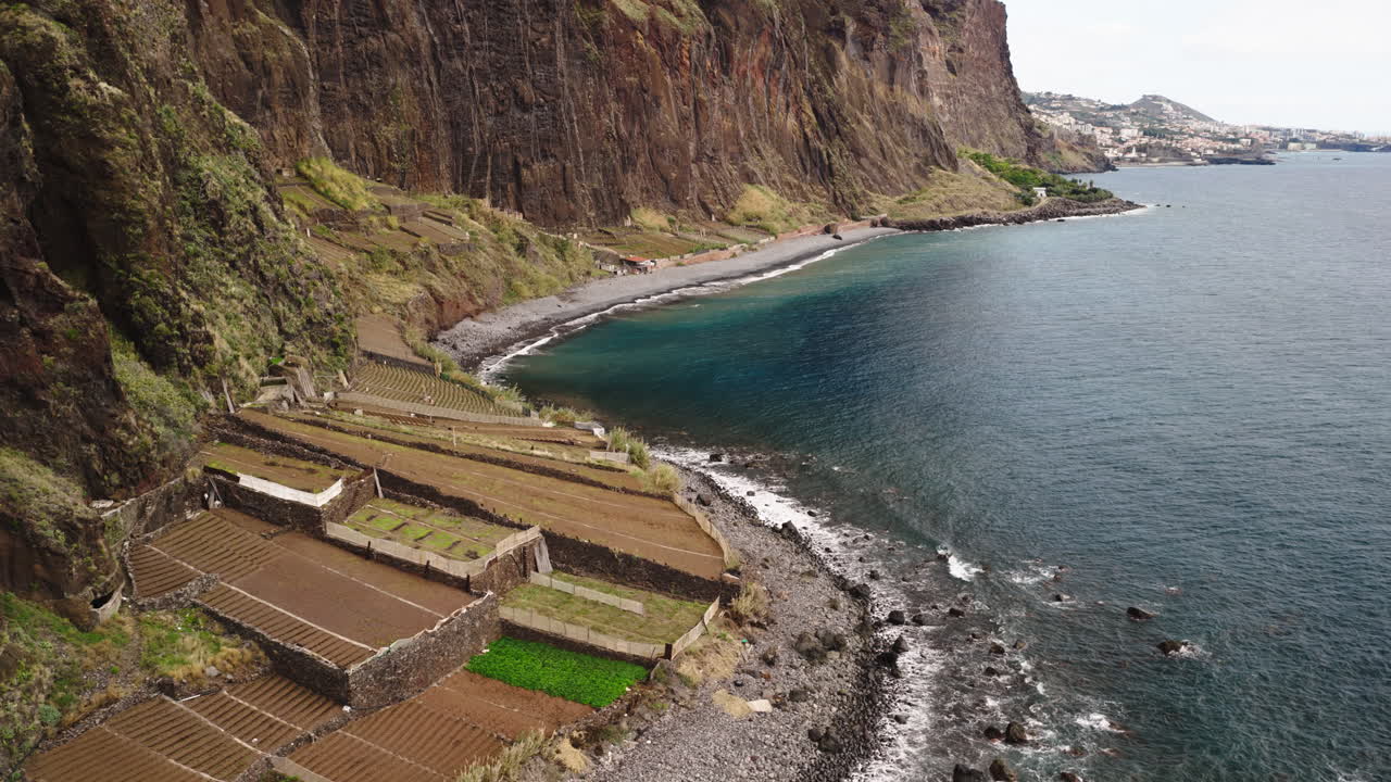 Vista Aérea de Falésias Costeiras Dramáticas com Culturas em Terraços e Ondas do Oceano
