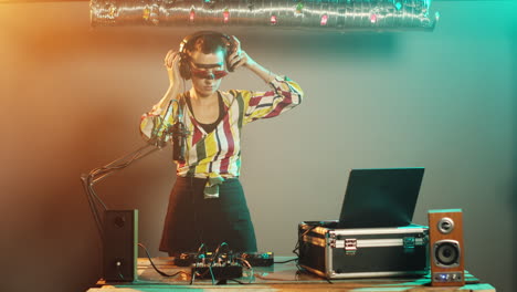 focused woman playing tunes at dj turntables