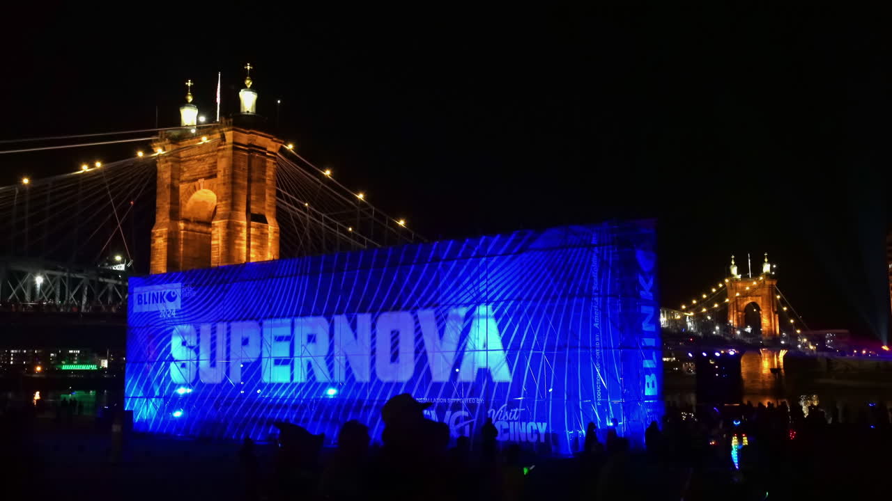Supernova sign in front of the Roebling "bridge of light", BLINK festival in Cincinnati