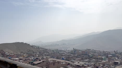 shanty town slum city over mountain range in manchay, lima, peru