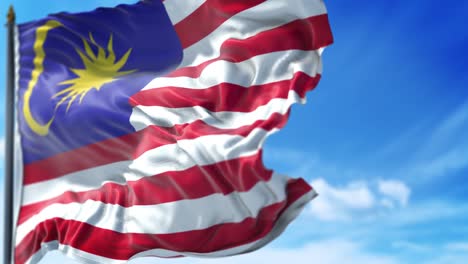 malaysian flag is waving slowly against blue sky