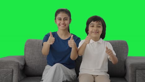 Happy-Indian-siblings-showing-thumbs-up-to-the-camera-Green-screen