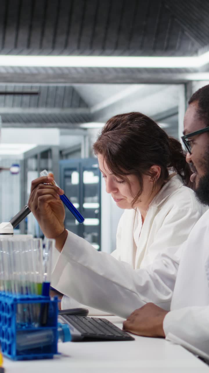 Vertical video Team of lab technicians using chemical solutions, creating mixtures