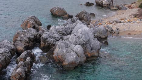 beautiful view demonstrating rocks into the sea in loutra, chalkidiki, greece