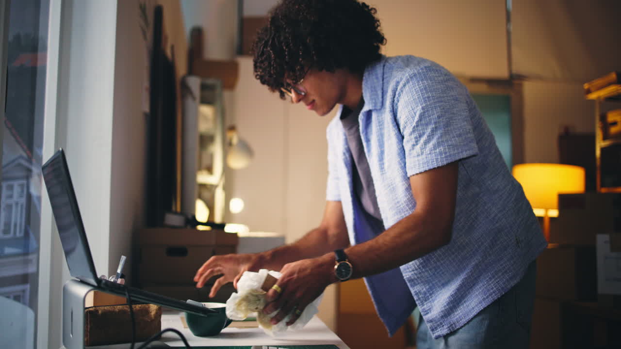 Young Man Cleaning and Organizing His Workspace
