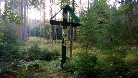 beautiful shot of isolated jesus christ on cross in heart of peaceful green nature