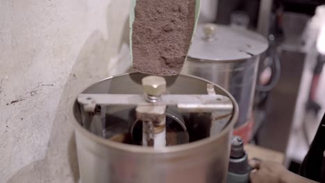 Crop-chocolatier-adding-cacao-powder-into-machine