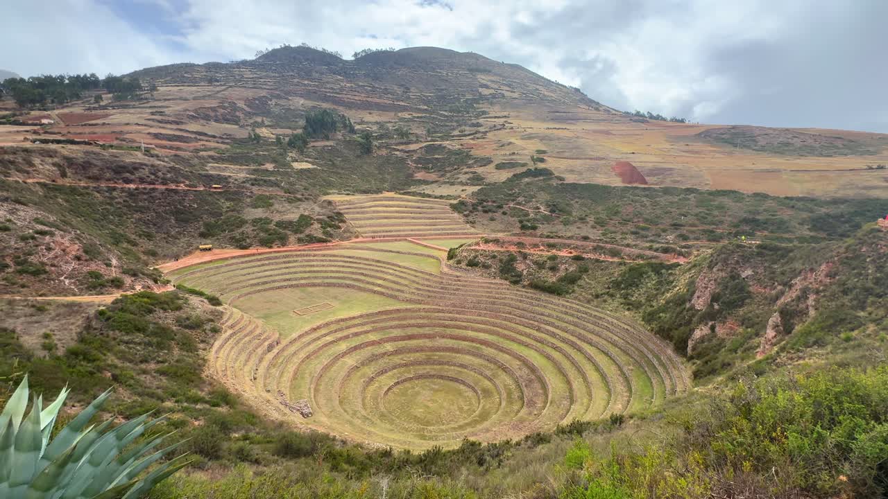 Sacred Valley Moray Zona arquelogica Moray Peru Perú circular terraces Salineras de Maras rainy season sunny cloudy Peruvian Andes Mount Patacancha Chicón Ancopacha Ollantaytambo Cusco region pan left