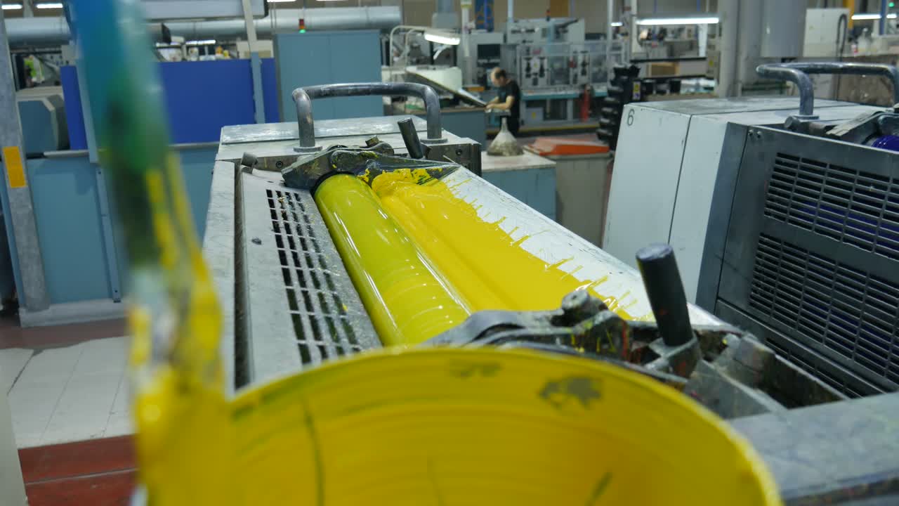 yellow paint in the process of printing by colors, the roll takes the paint it needs to print the labels in the factory's chain production