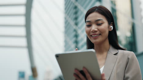 businesswoman using tablet outdoors