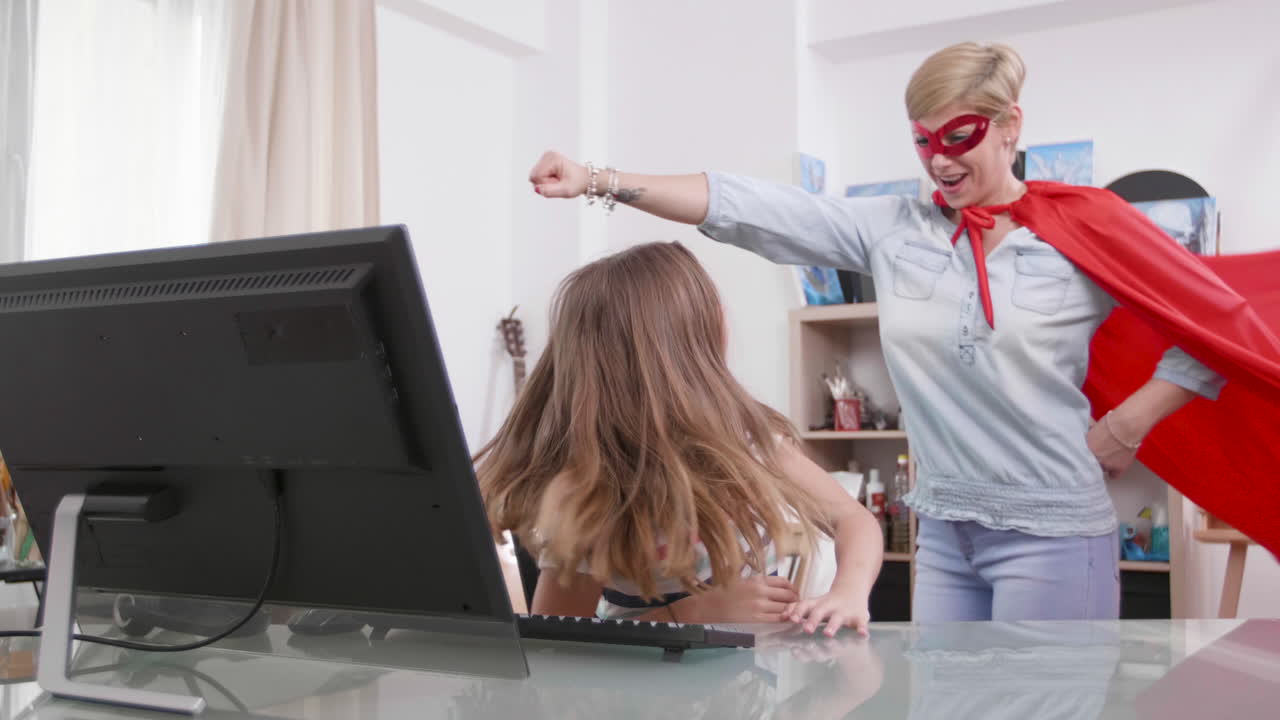 Mother and daughter playing superhero at home