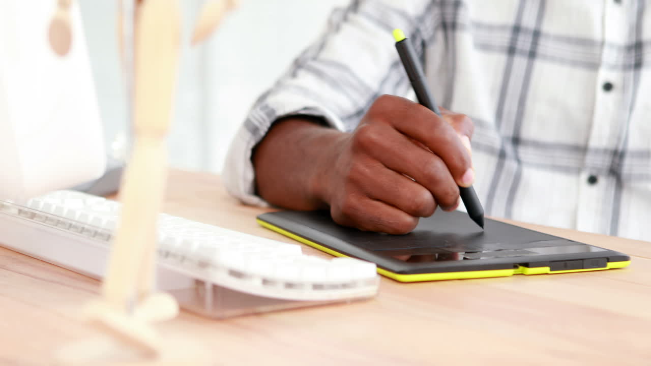 Serious businessman drawing on graphic tablet