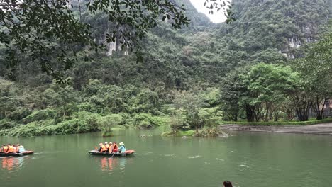 group rowing boats on a calm scenic river