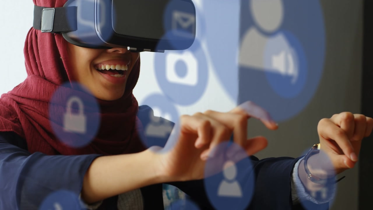 Animation of media icons over businesswoman using vr headset