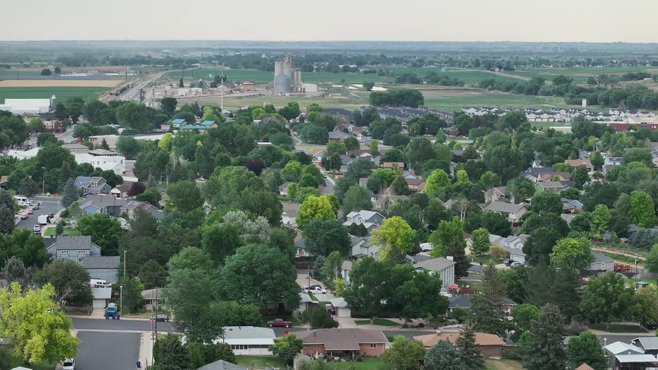Aerial establishing shot for real estate over Johnstown Colorado. Gentle flight toward he grain silos