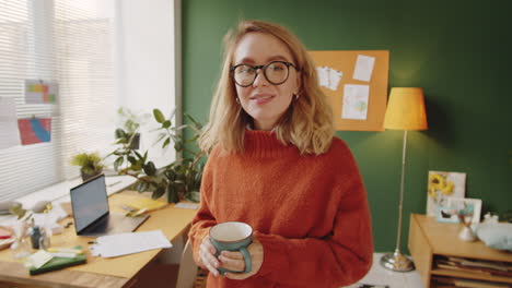 woman in home office with coffee