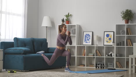 woman is squatting in living room of modern apartment training and doing physical exercise for health and beauty full lenght shot in house