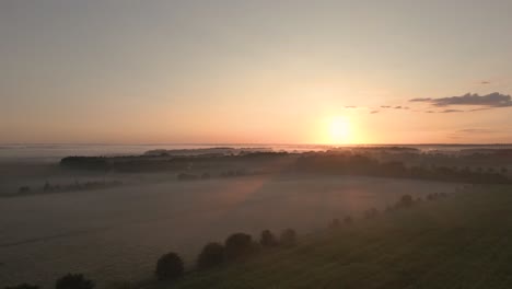 sunrise over misty fields