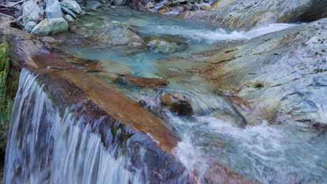 cold clear water runs over rocky slab waterfalls as it loses elevation