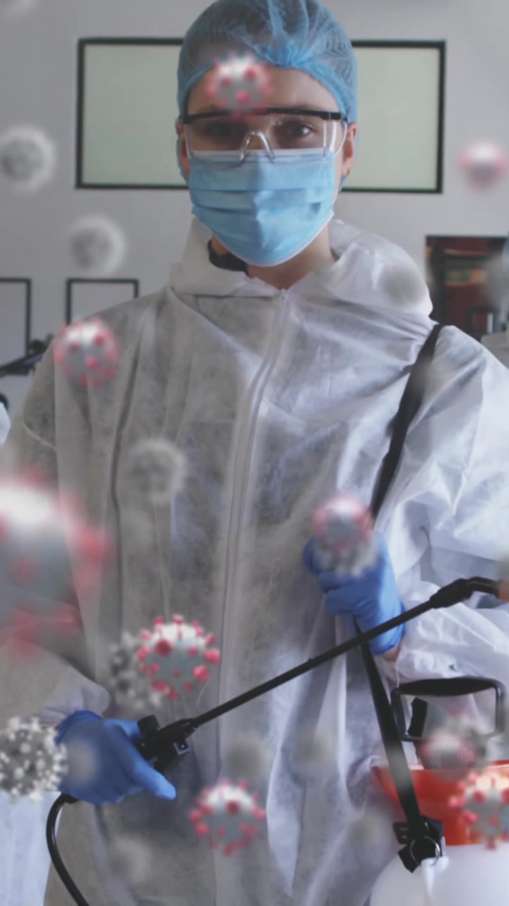 Multiple covid-19 cells over group of health workers holding disinfectant sprayer at the gym