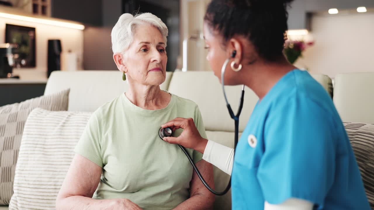 Nurse Using Stethoscope to Examine Elderly Woman at Home