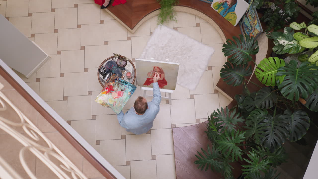 예술가는 가정 스튜디오에서 여성의 얼굴을 그립니다. 예술 제작자는 캔버스를 으로 만져서 스튜디오에서 여성 모델 초상화를 상상합니다. 남자는 창의적인 취미로 휴식을 취합니다.