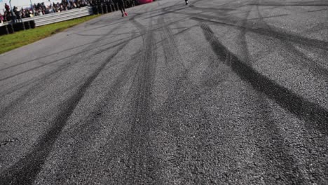 drift marks on an asphalt from drift tires, slow motion fly by