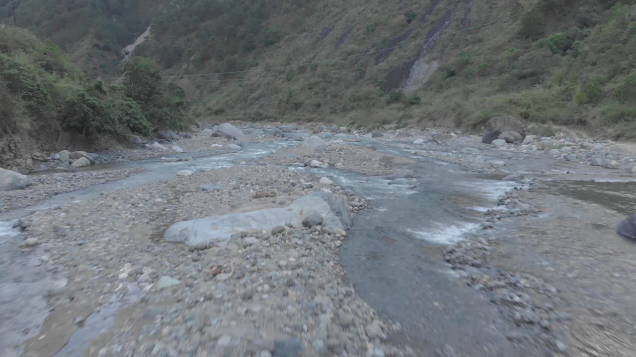 Natural mountain water river rapids flowing down valley in remote region fast wide approaching aerial over white water rapids rocks boulders majestic beautiful Benguet Philippines