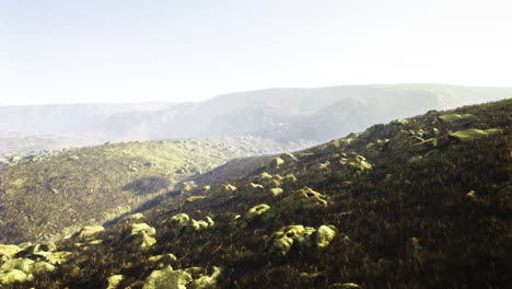 rugged landscape with rocky terrain and distant mountain views at sunrise