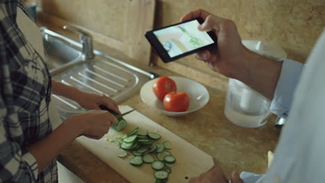 Couple Cooking Together, Following a Recipe on Smartphone