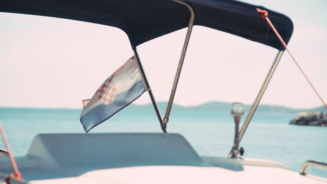 slow motion clip of a croatian flag moved by the wind on a boat during some navigation