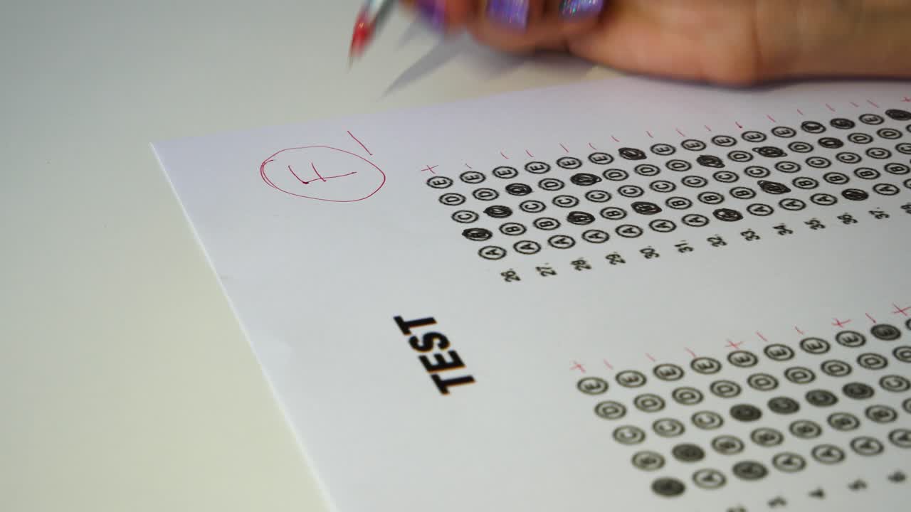 la mano joven del maestro que usa un bolígrafo rojo escribe el grado f y encierra en un círculo el puntaje de la prueba y la calificación