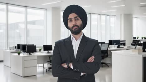 confident sikh indian businessman standing crossed hands