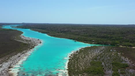 beautiful turquoise blue tropical bacalar lagoon in mexico on sunny day, aerial