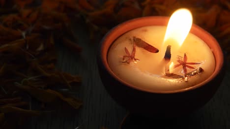 moving in and out on a jib from a diya or a tradition lamp used for various hindu festive celebrations for the festival of light- diwali and also for other prayers at home or a temple