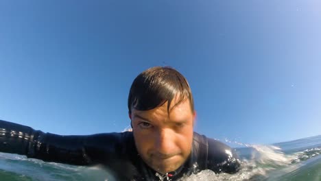 surfer on blue ocean wave surfing getting barrelled