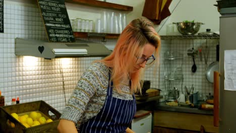 Woman-chopping-vegetables-in-cafe-kitchen-4k