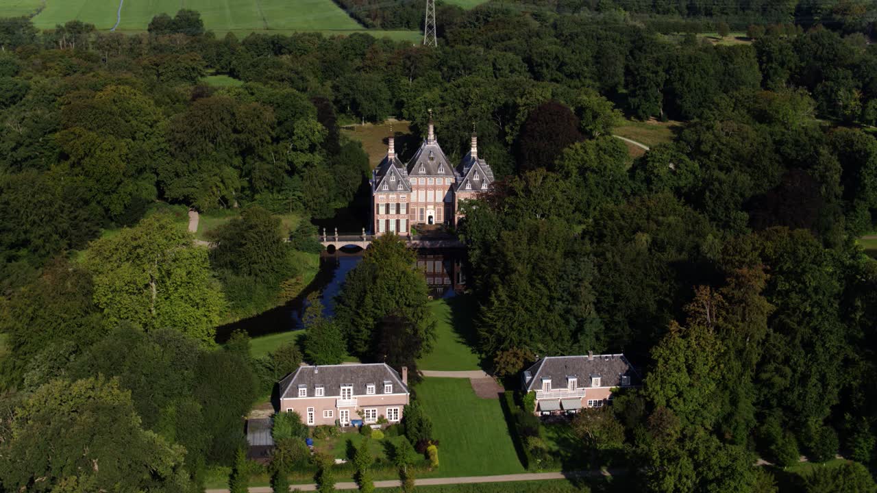 A dynamic horizontal aerial footage of the Castle Duivenvoorde in the town of Voorschoten, South Holland, in the Netherlands