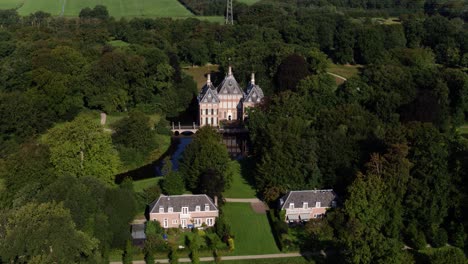 A-dynamic-horizontal-aerial-footage-of-the-Castle-Duivenvoorde-in-the-town-of-Voorschoten,-South-Holland,-in-the-Netherlands