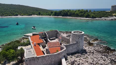 aerial orbits fortified building on small island in adriatic sea, mne