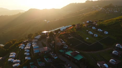 sunrise over mountain village with dome cabins