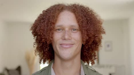 Portrait-of-happy-caucasian-man-with-red-hair-and-freckles-smiling-at-home-in-slow-motion
