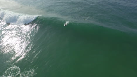 Bodyboarder-wearing-red-lycra-catching-a-wave-and-doing-some-manoeuvres