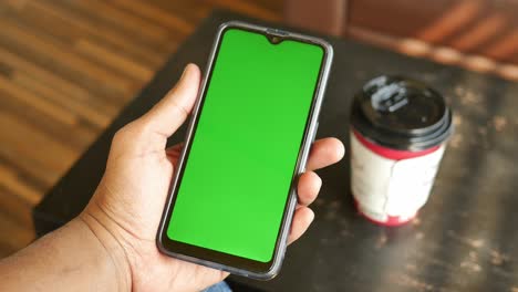 close up of young man hand using smart phone