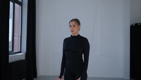 woman in black activewear doing yoga stretches in a studio